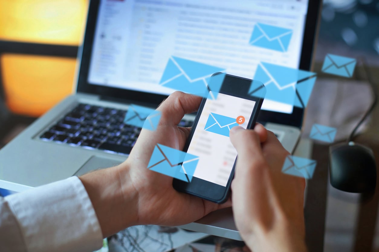 person reading e-mail on smartphone, Email aliases for your business mailbox are essential for small and medium-sized enterprises (SMEs) and startups